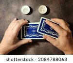Small photo of female hands shuffle tarot cards, solitaire layout close-up