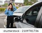 Small photo of Woman drivers call insurance after a car accident before taking pictures and sending insurance. Online car accident insurance claim idea after submitting photos and evidence to an insurance company.