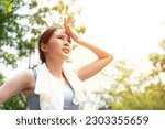 Small photo of Sport asian woman gets tired and get dizzy, feel bad pain and suffer from heat stroke outdoors when jogging or exercise outdoor with strong sunlight in summer season. Heatstroke and heat wave concept.