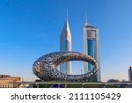Small photo of Dubai, UAE - November 27, 2021: Panoramic view of Museum of Future and Emirates towers buildings. Modern futuristic Museum built according designed by architect Shaun Killa.