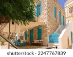 Colorful fishing village of Symi with colorful houses and doors, flower pots on Symi Island in Greece. High quality photo