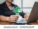Small photo of LiFi (Light Fidelity), Businessman holding a light bulb with new technology for internet connection. Business, technology, internet and networking concept, businessman showing hi-speed connection.