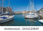 Small photo of Grado, Grado, Friuli Venezia Giulia, Italy-15 May 2023: Cityscape of Grado, Italy. View of a canal in centrum of tourist town Grado with sailboats on the water.