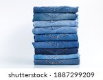 Jeans trousers stack   on a white background concept jeans in supermarket and shop.
