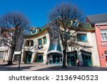 Small photo of August 30, 2020 - Gdansk Poland. unusual red building Krzywy Domek dancing on the shopping street in Sopot