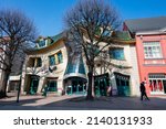 Small photo of September 4, 2020 - Gdansk Poland. unusual red building Krzywy Domek dancing on the shopping street in Sopot