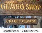 Small photo of New Orleans, LA - circa January 2022: Wooden sign for the famous Gumbo Shop in the French Quarter, serving Creole Cuisine.