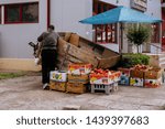 Small photo of Man selling fruits and vegetables on a street using a extempore, self made showcase. Braila, Romania - May 2019