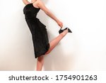 Woman In A Black Dress And Shoes