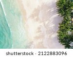 Small photo of Aerial view top view Beautiful topical beach with white sand coconut palm trees and sea. Top view empty and clean beach. Waves crashing empty beach from above. With copy space.