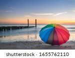 Rainbow Umbrella On The Beach...