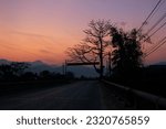 Small photo of A journey homeward as the sun sets, revealing a mesmerizing sky of radiant reds and purples. Rugged mountains fade into the twilight, while the cloudless, azure sky add enchantment to the moment
