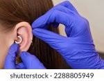 Small photo of piercings on an ear. Conch and helix piercings close up