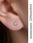 Small photo of piercings on an ear. Conch and helix piercings close up