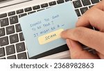 Small photo of Scam alert concept. Finger pointing a note with the words Sounds Too Good To Be True It Might Be A Scam