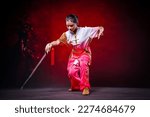 Chinese girl holding sword with Chinese martial arts concept.