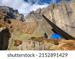 Hiker Pitching Tent In A...