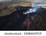 Small photo of Volcano eruption in Iceland, summit crater, gas expulsion, and molten lava spilling out from a vent, aerial side view. Natural hazard and geothermal energy concepts.