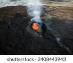 Small photo of Apocalyptic surroundings of an erupted volcano, red hot lava boiling and pouring down the crater, volcanic gases and smoke spreading around the area, aerial side view.