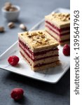 Small photo of Pistachio biscuit layered cake with fresh raspberry, square pieces, grey concrete background, nordic style