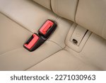 Small photo of Seat belt and Isofix for child car seats. Installing Isofix baby car seats for safety and to comply with the law. Interior of new clean expensive car. Seats with nappa beige leather. Details closeup.