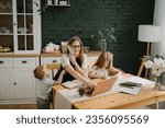Small photo of Angry and tired mother working with kids at home. Woman working, learns on laptop computer. Children playing, make noise, distract, disturb mom. Writing, typing. Technology concept. Maternity leave