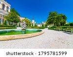 The Mikulov castle, Czech republic. Famous medieval castle on top of hill. Beautiful ornament garden with flowers, trees and green grass. Summer weather and blue sky. Beautiful wine region near Palava