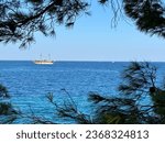 White yacht in the bay of the Adriatic Sea. Holidays on the open sea on a small boat. Boat with a sail near the sea coast. Croatia, Adriatic coast 10 September 2023