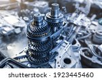 Closeup disassembled car automatic transmission gear part on workbench at garage or repair factory station for fix service or maintenance. Vehicle part detail. Complex industrial mechanism background
