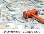 Judge hammer on American money background. Fraud tax fines. Law, judgment and justice concept.