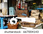 Small photo of British junk shop with baskets, a bust and other bric-a-brac, with the positive message "Live Well"
