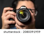 Small photo of photographer take pictures Snapshot with camera. man hand holding with camera looking through lens.Concept for photographing articles Professionally.