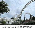 Two rollercoasters next to a...