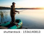 Male Fisherman At Dawn On The...