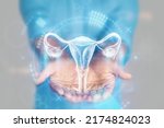 Small photo of Medical concept, doctor's hands in a blue coat close-up. Ultrasound of the uterus, x-ray, hologram. Medical care, woman anatomy, doctor's appointment, reproductive system. mixed media