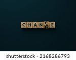Wooden blocks with the word CHANGE changing the letter G to C so that the word CHANCE appears.