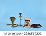 Small photo of Shivaratri background with Shivas trident, Pellet Drum Damroo musical instrument ans snake . Maha Shivratri festval