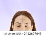 Woman with cross made from ash on forehead. Ash wednesday concept.