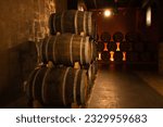 Small photo of Yerevan, Armenia - May 28 2023: Cellar of the Ararat brandy factory in Yerevan. Close up barrels of cognac in the cellar.