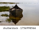 Old Boat Stands In Calm Waters