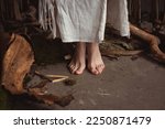 Close up barefoot woman standing in woodworking workshop concept photo. Front view photography with wood on background. Carpentry. High quality picture for wallpaper, travel blog, magazine, article