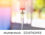 Small photo of Set vitamin iv fluid intravenous drop saline drip hospital room Medical Concept treatment emergency and injection drug infusion care chemotherapy concept.blue light background selective focus
