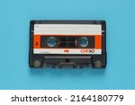 Audio cassette tape isolated on blue background, Vintage retro gadgets for The 70-80-90's