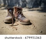 Heavily Used Work Boots On The...
