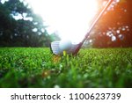 golf club and golf ball close up in grass field with sunset. Golf ball close up in golf coures at Thailand