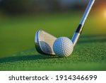 Small photo of Golf club and ball in grass concept. Golf balls on the golf course with golf clubs ready for the first short. In the morning, with the beautiful sunlight.