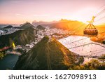 Small photo of Famous and Touristic Cable Car from Sugar Loaf Mountain (also known as Bondinho do Pao de Acucar), Popular Attraction Overlooking the Beautiful City of Rio de Janeiro, Brazil, During a Golden Sunset