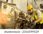 Small photo of Engineering mechanic wearing safety goggles to prevent accidental scrap metal getting into eyes : Male factory lathe operator wearing safety uniform while machine working : Service metalwork industry.