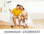 Small photo of Cheerful asian couple sitting happily together in family home sharing family despite sick husband and disabled wife wearing prosthetic legs : Health insurance and accident insurance concept.