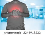 Small photo of Image of a patient holding his hand in the middle of his chest Caused by acid reflux or from underlying diseases such as heart disease,Medical healthcare concept.